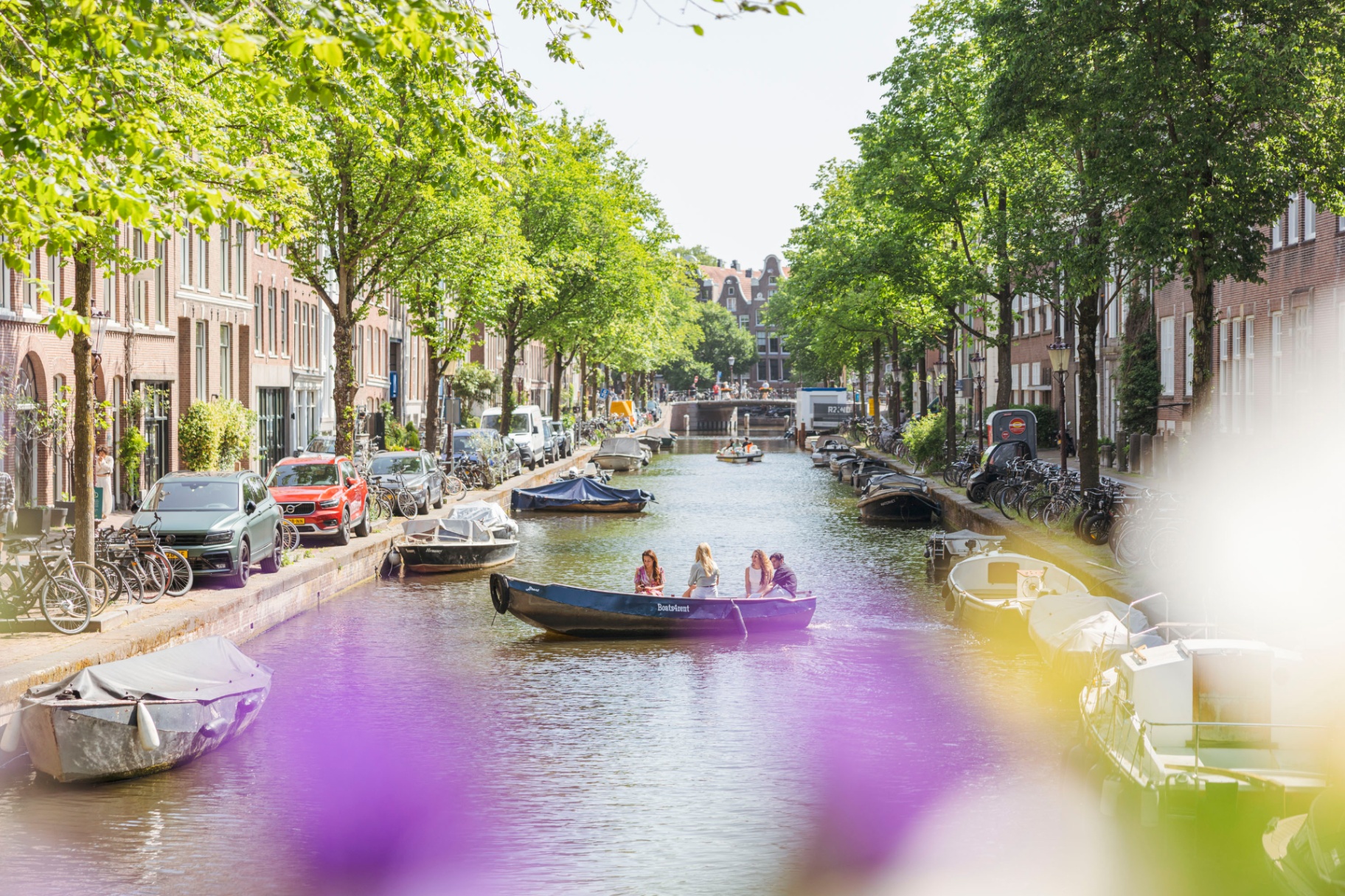Boats4rent electric boat in characteristic Amsterdam canal with bridge
